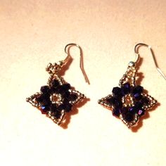 a pair of earrings is shown on a table