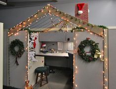 an office cubicle decorated with christmas lights and wreaths