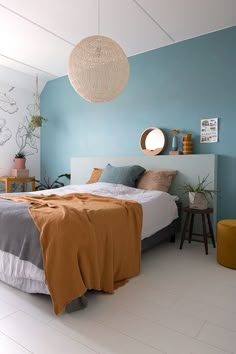 a bedroom with blue walls and white floors