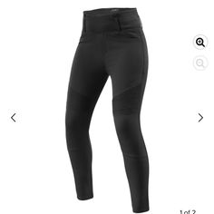 the side view of a pair of black pants with zippers on each side and one leg