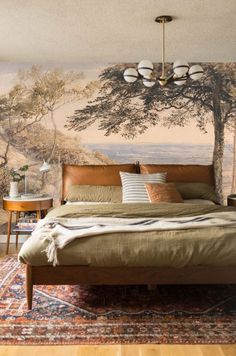 a bedroom with a large mural on the wall