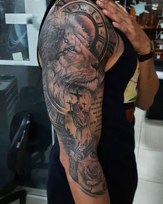 a man with a lion tattoo on his arm