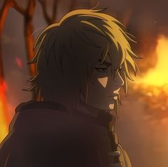 an anime character with blonde hair standing in front of a tree and flames behind him