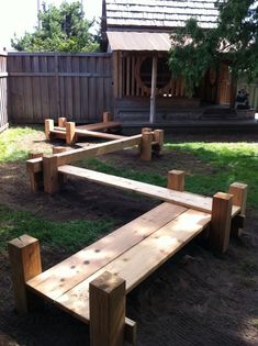 a wooden bench sitting in the middle of a yard