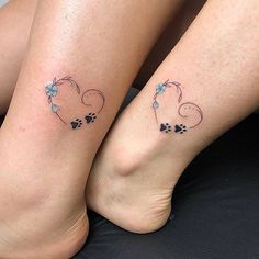 two people with matching tattoos on their legs, one has a dog and the other has a cat