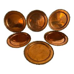 six antique copper plated dishes on a white background