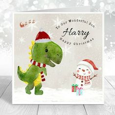 a christmas card with a dinosaur and snowman