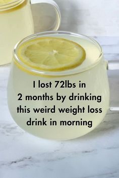 a glass filled with lemonade sitting on top of a table