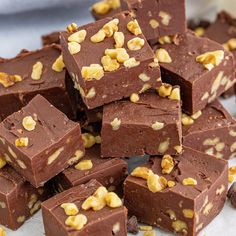 several pieces of chocolate fudge on a white plate with walnuts in the middle