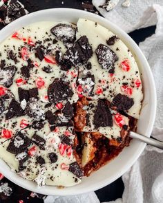 a white bowl filled with chocolate and peppermint covered dessert