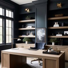 a home office with black walls and wooden desks, built in bookshelves