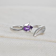 Sterling Silver Purple Amethyst Tulip Flower Leaf Detail Ring. Set with a pear shaped natural African Purple Amethyst. The ring is an adjustable design in two sizes. I'm a big fan of developing designs for adjustable rings. They give that bit of flexibility if your size varies with the seasons, as mine does, or convenience if you're buying a gift that it will fit the recipient. Topaz are associated with love self esteem and good fortune. They are the birthstone for December. Finished with a commercial grade rhodium plate to give a high quality shine finish. Supplied in an Ojewellery presentation box, within a ribbon handled gift bag, complete with product information authenticity card with space for a gift message and a jewellery cleaning cloth to keep your jewellery in ready to wear condi Tulip Ring, Argentium Silver Jewelry, Pretty Jewelry Necklaces, Tulip Flower, Flower Leaf, Detailed Ring, Pretty Jewelry, Purple Band, Argentium Silver