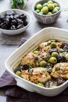 a casserole dish with olives and chicken