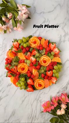 the fruit platter is made up of oranges, strawberries and grapes