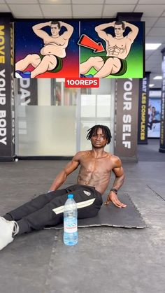 a man sitting on top of a mat in front of a water bottle and sign