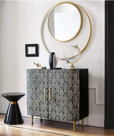 a black and white cabinet with gold accents