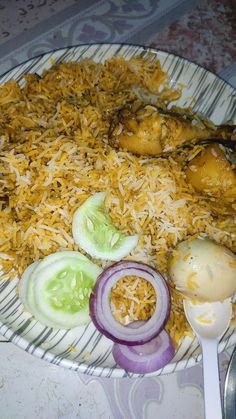 a plate filled with rice, onions and other foods