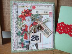 a close up of a christmas card with a santa clause on it and a red flower