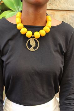 Handmade in Nairobi , Kenya!A beautiful. statement, necklace crafted with african beads, a brass pendant and finished with a brass clasp.***SHIPPINGShipping is done via DHL Express, 3-7 days delivery,Add multiple items to your cart and pay shipping for one item ONLY! Unique Pendant Beaded Necklace, Unique Wooden Beaded Necklaces, Gift Beaded Necklaces With Wooden Beads, Gift Wooden Beaded Necklaces, Gift Wooden Beads Necklace, Gift Jewelry With Large Beads, Large Beads Pendant Necklace For Jewelry Making, Large Beads Pendant Necklace For Gift, Large Beads Round Pendant Necklace As Gift