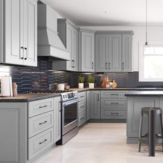 a kitchen with gray cabinets and counter tops