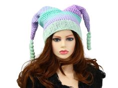 Have some winter fun and stand out with this pastel Royal Court Jester Hat. I've crocheted this in pastel purples and greens, with a matching knitted subtle sparkle ribbed band for easy stretch and fit. The greens  blur and blend through the purples at different points. It gives a touch of royal fae, or impish sprite vibes and is just pure fun. Certain to add a unique character when you are out and about, skiing, snowboarding, going to an outdoor concert, a festival, hiking through the forest, or even a fun costume accessory! Makes a fun gift for him or her. Lots of stretch, so one size will fit most. Machine wash cold and lay flat to dry. Whimsical Winter Yarn Mini Hats, Whimsical Yarn Mini Hats For Winter, Whimsical Multicolor Crochet Hat For Winter, Adjustable Multicolor Costume Hats And Headpieces For Winter, Winter Crochet Costume Hats And Headpieces, Whimsical Crochet Cap For Winter, Whimsical Winter Crochet Cap, Adjustable Whimsical Crochet Hat, Whimsical Adjustable Crochet Winter Hat