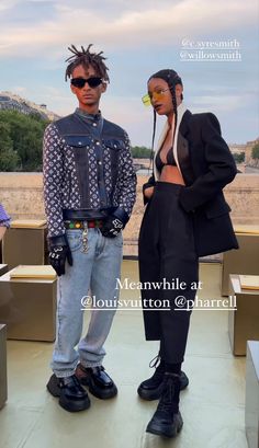 two people standing next to each other in front of the eiffel tower