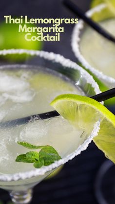 two margaritas are garnished with lime and sugar, one is on the rim