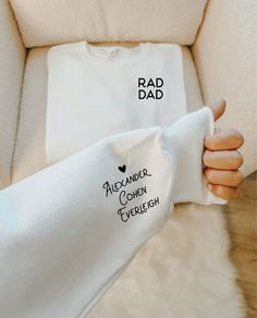 someone is holding up a white t - shirt with the words rad dad on it