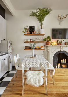 a dining room with a table and chairs next to a fire place in the fireplace