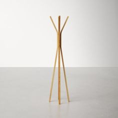 a wooden coat stand with three legs and two hooks on each end, against a white background