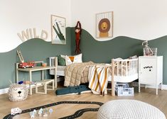 a child's bedroom decorated in green and white