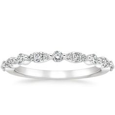 a white gold wedding ring with five diamonds on the top and bottom, set in 18k