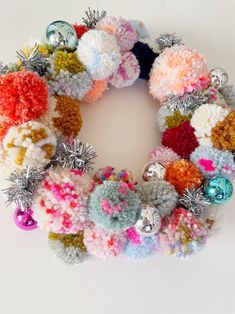 a multicolored crocheted wreath with bells and ornaments