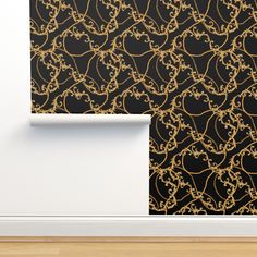 a black and gold wallpaper with an intricate design on it's side, next to a white door