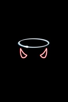 a black background with red and white lights in the shape of two eyes on top of a circular object