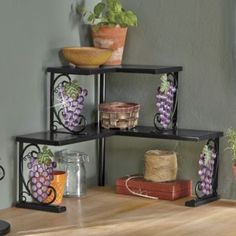 three tiered shelving unit with grapes and other items on top of the shelf