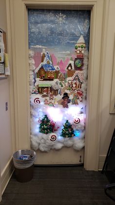 a door decorated with christmas decorations and lights in the shape of santa's village