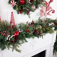 christmas decorations are arranged on the mantel