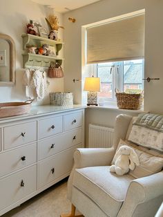 a baby's room with a rocking chair and dresser