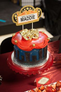 there is a birthday cake with strawberries on it and the name maddie written in gold