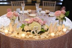 the table is set with flowers and candles for an elegant wedding reception at the hotel