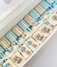 a box filled with lots of blue and white cookies on top of eachother