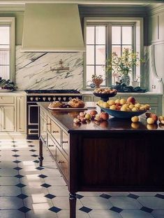 an image of a kitchen with fruit on the counter and in the middle of it