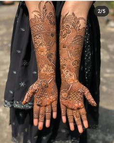 two hands with henna tattoos on them