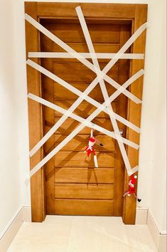 a wooden door with white tape taped around it