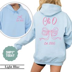 a girl wearing a blue hoodie with pink lettering on it and the back of her sweatshirt