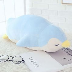 a stuffed animal with glasses on top of it next to a book and eyeglasses