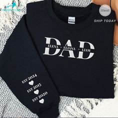 🎄 Holiday Shipping Reminder 🎄 Place your order by December 7, 2024 to ensure delivery before Christmas.❤️ Celebrate dad's newest chapter with our "Dad EST 2024" Embroidered Sweatshirt, personalized with kids' names for a unique, thoughtful gift that commemorates his journey. Ideal for Father's Day, this retro-styled sweatshirt is a great gift for grandpa or daddy, adding a stylish and personal touch to his wardrobe as he embraces fatherhood. ❤️ P R O D U C T * I N F O Minimalistic, casual, and Long Sleeve Top With Text Print For Father's Day, Father's Day Casual Sweatshirt With Name Print, Names For Him, Father's Day Cotton Sweatshirt With Name Print, Styled Sweatshirt, Customizable Long Sleeve Sweatshirt For Father's Day, Father’s Day Name Print Crew Neck Shirt, Father's Day Graphic Print Long Sleeve Sweatshirt, Personalized Crew Neck T-shirt For Father's Day