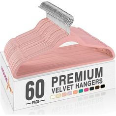 a pink plastic hanger in a white box with the words premium velvett hangers on it