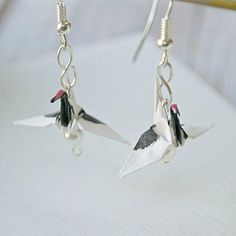 Origami crane earrings. Made of paper and sprayed with an acrylic sealant. Measurement Length (from your piercing to the bottom of earrings) : 1.25" Object : 0.75" Paper Crane Earrings, Crested Crane, Lesbian Earrings, Crane Earrings, Origami Earrings, Crafts Origami, Origami Jewelry, How To Make Origami, Asian Jewelry